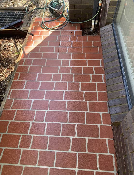 Freshly pressure-washed brick pathway, before and after results