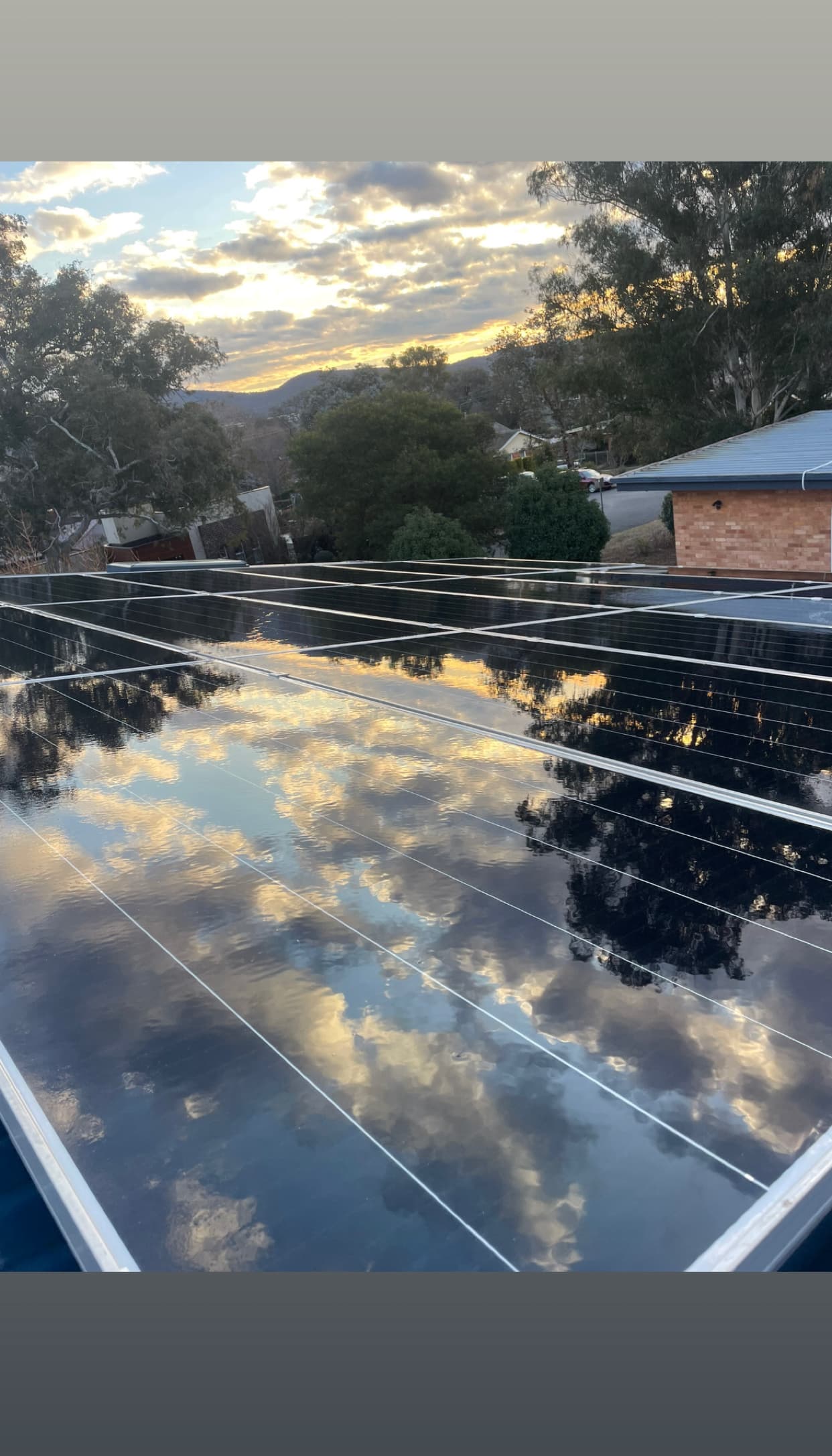 Freshly cleaned rooftop solar panels reflecting the Canberra sky