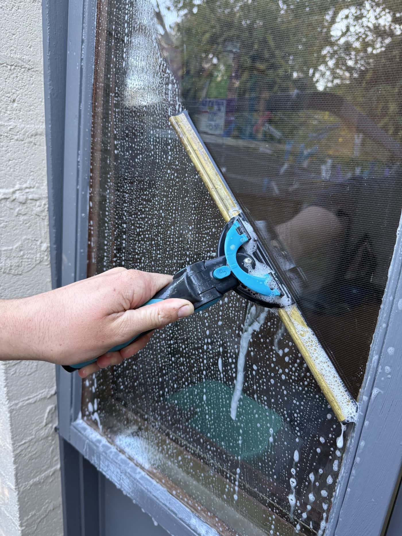 Close-up of squeegee leaving a streak-free finish on a Canberra window